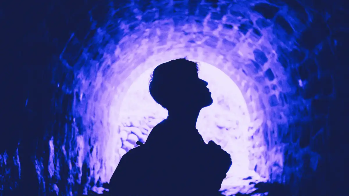 Silhouette of a figure inside a glowing tunnel symbolizing nostalgia driving WWE growth over new stars.